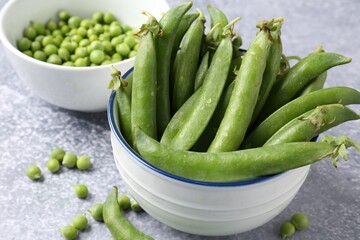 Fresh ripe green peas on grey table, closeup