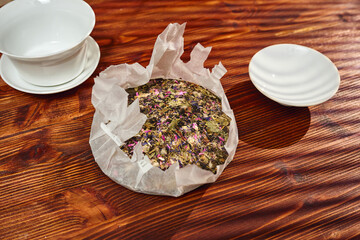 A vibrant mix of dried herbs and colorful petals is arranged on parchment paper