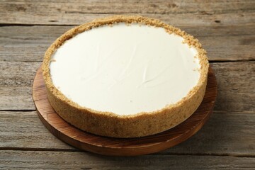 One tasty cheesecake on wooden table, closeup