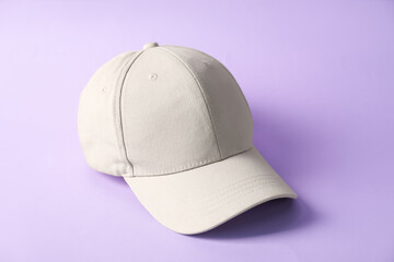 One beige baseball hat on violet background