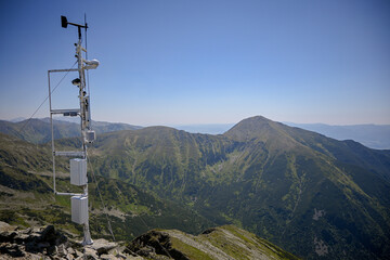 Automated weather station collecting meteorological data in a remote mountain area, contributing to...