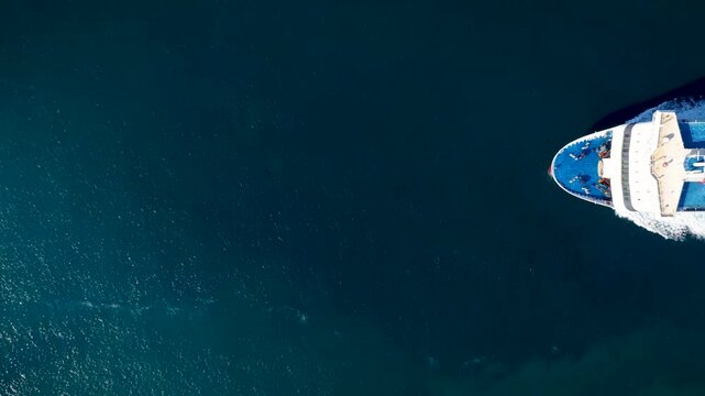 Aerial overhead view of a passenger RoRo (Roll on Roll off) ship crossing the ocean with speed