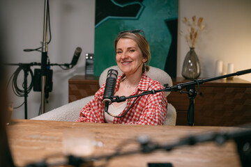 Video podcast recording studio. A conversation between a man and a woman sitting in front of...