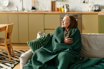 Enjoying cozy moments at home with a warm blanket and a peaceful expression