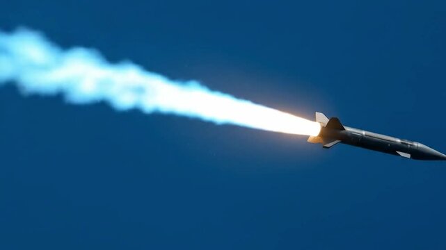 Supersonic missile launches with bright exhaust trail through blue sky, representing high-speed precision weaponry