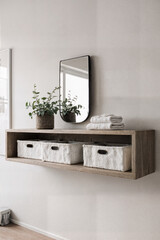 Floating shelf with small mirror and linen storage compartment