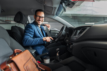 Smiling Businessman Securing Seatbelt While Sitting in a Car Interior