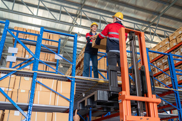 Warehouse worker working in warehouse storage. Foreman or worker work at factory site check up...