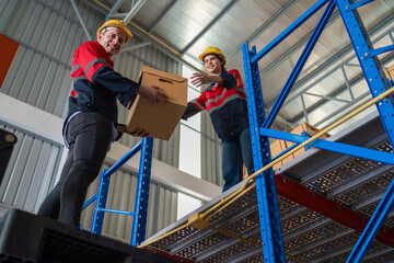 Warehouse worker working in warehouse storage. Foreman or worker work at factory site check up...