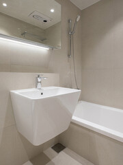 A bathroom structure with the sink and bathtub placed side by side.jpg