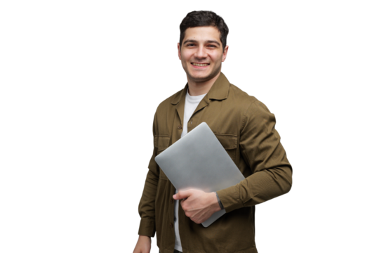 Confident young man stands holding a laptop in a bright, minimalist space, showcasing modern tech-savviness and professionalism
