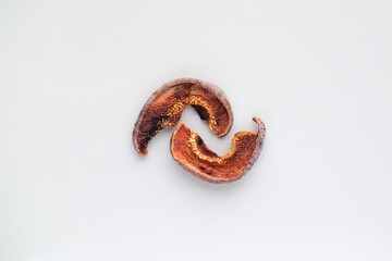 Several pieces of dry fruits on a white background. Healthy preserves dried fruits. A pile of dried fruit. Top view