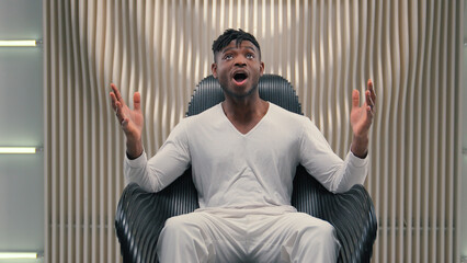 African American cyber man amazed shocked saying wow reaction astonish looking at camera wonder...