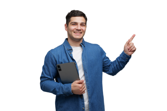 Smiling young man in casual denim shirt holds tablet while pointing with excitement transparent background