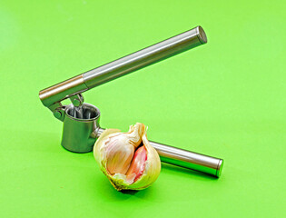 Modern metal garlic crusher tool with bulb on the side