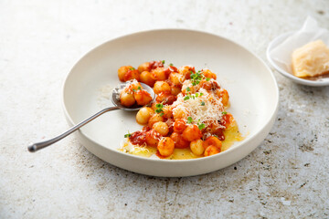 Potato gnocchi with tomato and cheese