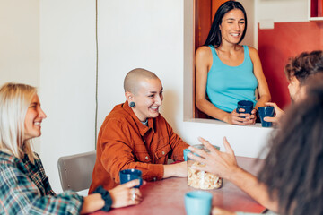 Diverse friends enjoying coffee and conversation at home - youth hostel - coliving 