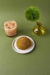 choux cream on a plate and coffee glass over green background. Japanese Shu Cream