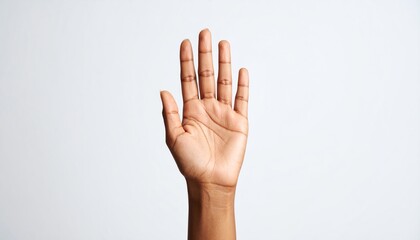 Beautiful female hand with the number one gesture facing upwards on a clean white background in a joyful expression