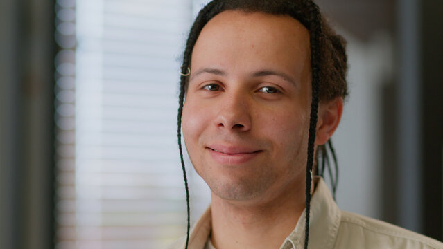 Close up headshot male ethnic businessman smiling face portrait business man American guy professional with dreadlocks braids looking at camera smile in office company working startup manager indoors