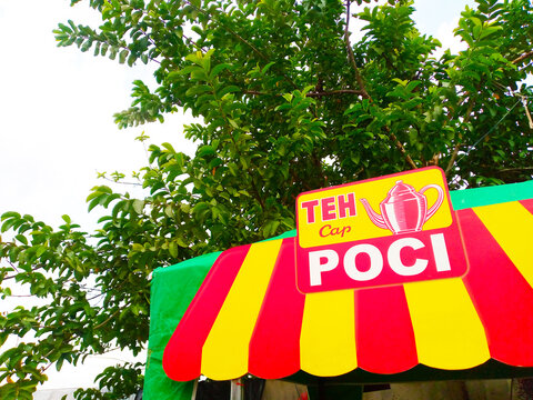 Traditional Teh Poci Stall with Colorful Awning in Indonesia, Teh Poci Signboard at Local Tea Stall. On 1 Desember 2024, Bekasi, Indonesia.