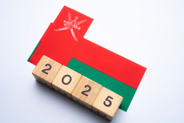 2025, Oman flag with date block, Concept, Important events for Oman the new year, election, economy, social activities, central bank, Oman foreign policy