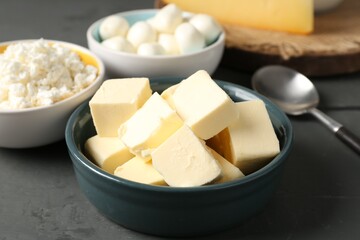 Different dairy products on grey wooden table, closeup