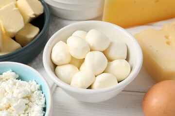 Different dairy products on white wooden table, closeup