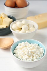 Different dairy products and eggs on white wooden table, closeup