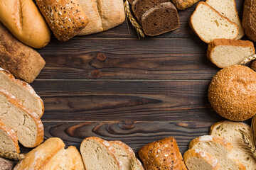 Homemade natural breads. Different kinds of fresh bread as background, top view with copy space