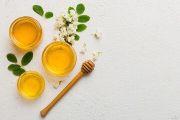 honey jar with acacia flowers and leaves. fresh honey top view flat lay