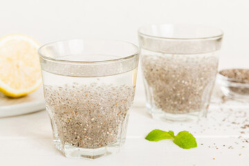 Healthy breakfast or morning with chia seeds lemon and mint on table background, vegetarian food,...