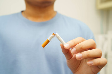 Quit smoking, Asian man breaking destroy cigarette in hand.