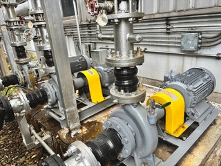 Large industrial pumps and insulated piping system in a modern chiller plant. Key components for thermal energy transfer and HVAC operations in commercial or industrial facilities.