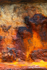 Textured corrosion. Worn iron with patina.