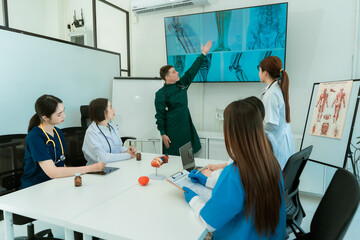 Medical team working on digital tablet technology for medical use using computers to analyze,...