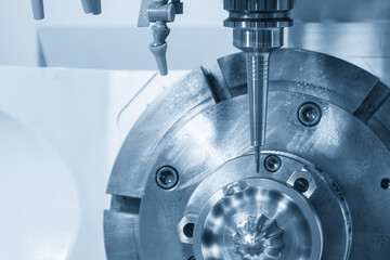 The 5 axis CNC milling machine cutting mold part by solid barrel  end mill tool in the light blue...