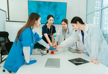 Fototapeta premium medical team working together Group of doctors and surgeons shake hands and exchange hands before operating on a patient in the hospital operating theater.