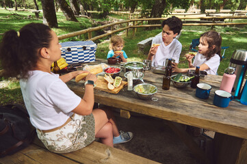 Family Enjoying Outdoor Picnic Together in a Scenic Forest Setting