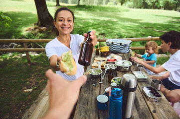 Family Enjoying a Relaxing Outdoor Picnic Together in a Scenic Park Setting