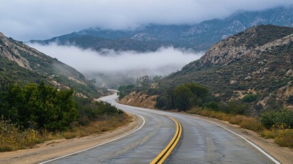 Winding road through a misty mountain pass.