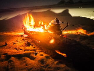 Campfire in the night camp in the White Desert in Egypt. Fire under the sky