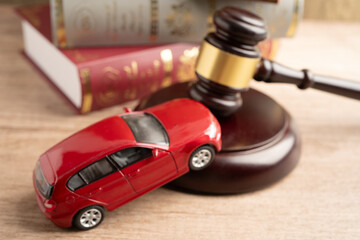 Car accident lawsuit and insurance, Judge hammer with car model.
