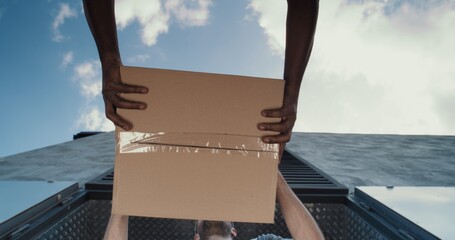 Low Angle Shot of Multiethnic Employees Unloading Cardboard Boxes with Online Orders, Purchases and...