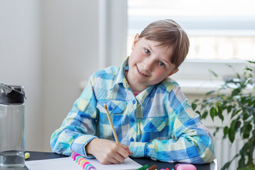 Smiling child doing schoolwork at desk
