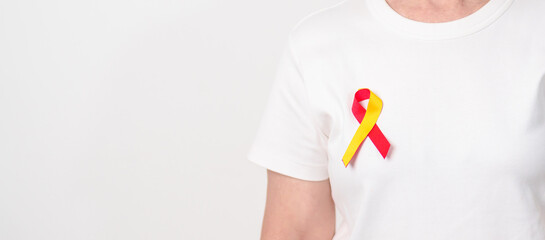 World hepatitis day awareness month, 28 July. elderly woman with Red and Yellow ribbon. Liver...