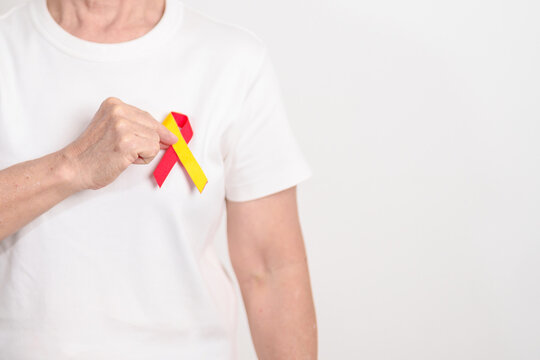 World hepatitis day awareness month, 28 July. elderly woman with Red and Yellow ribbon. Liver cancer, Jaundice, Cirrhosis, Failure, Enlarged, Hepatic Encephalopathy and Health concept