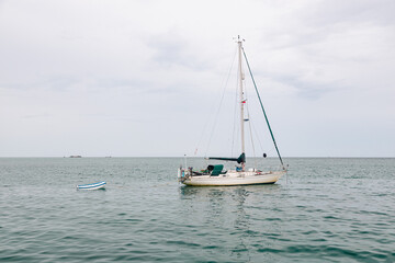 sailboat on the sea with smaller boat