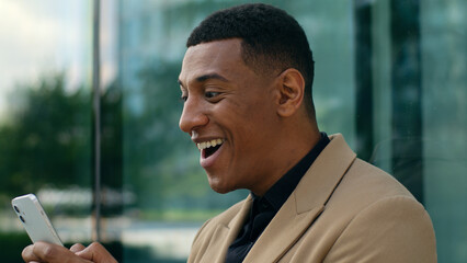 Happy smiling African American business man in city outdoors office building smile employer...