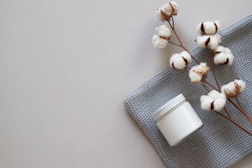Blank White Cosmetic Jar on Gray Knit Fabric with Cotton Branch for Branding Mockup